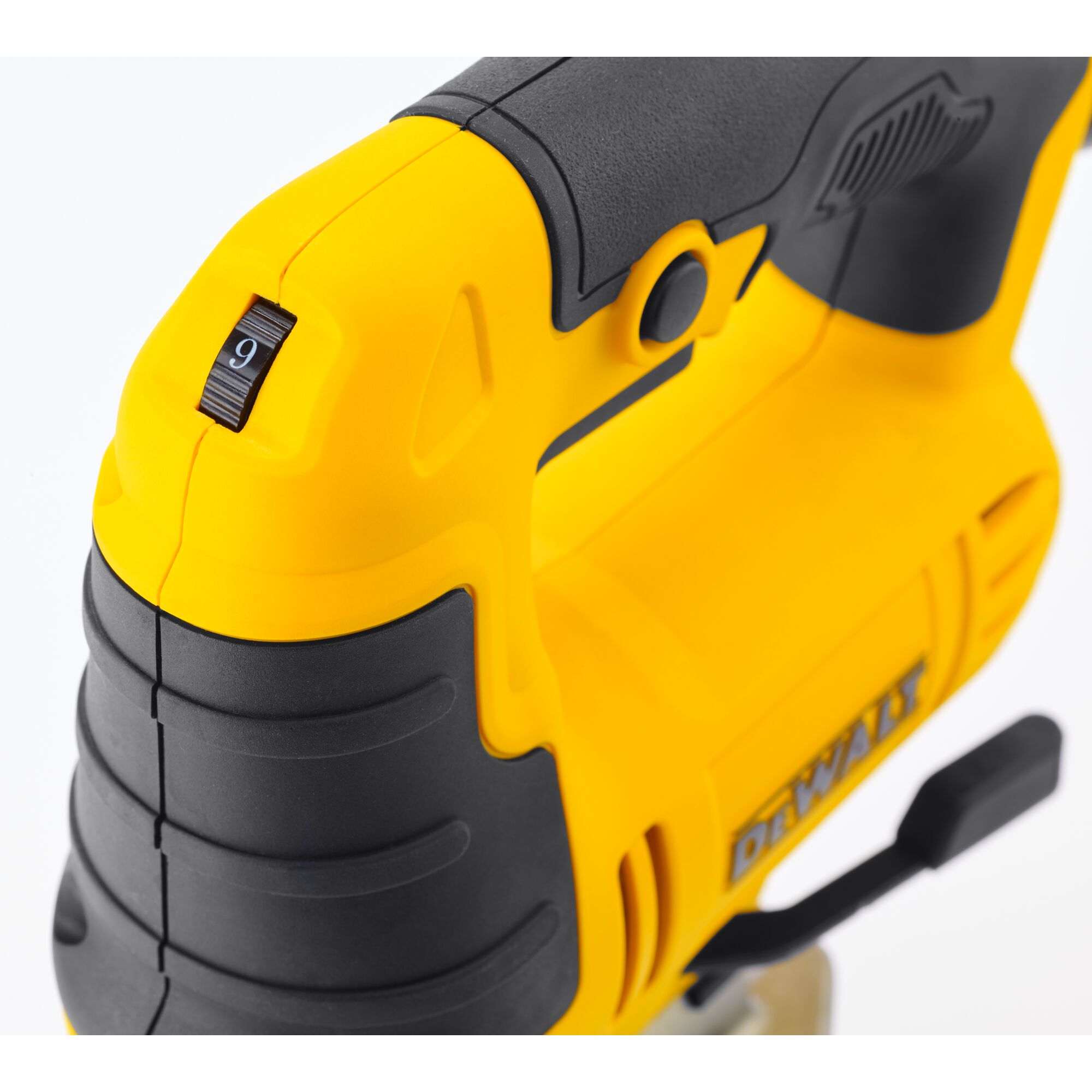 Close-up view of a DEWALT yellow and black jigsaw handle showing the speed adjustment dial and ergonomic grip.